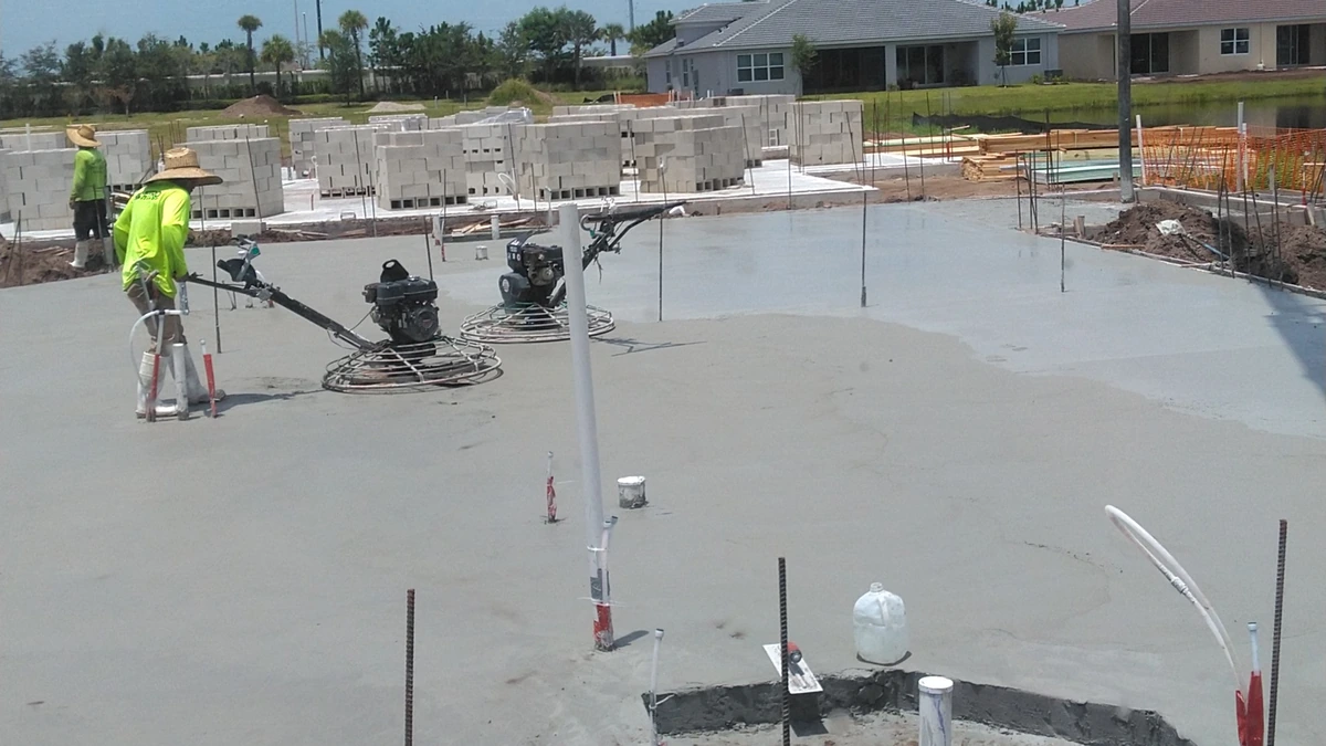Concrete boom pump truck placing a house foundation on a Florida building lot