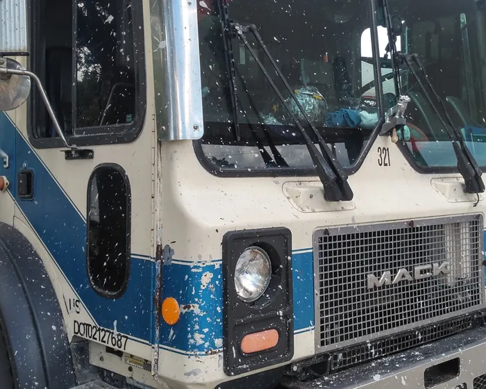 Cream and blue Mack cab over concrete boom pump truck, unit 321